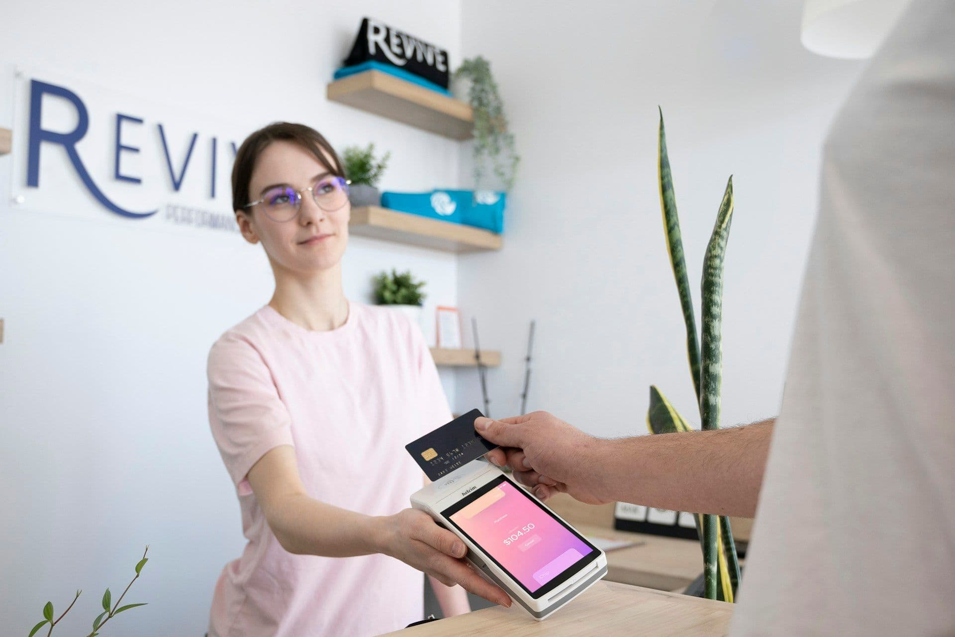 Customer handing a payment card across a counter